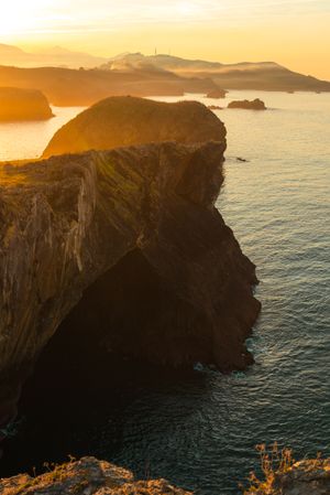 Majestic cliffs of ocean coastline in sunset