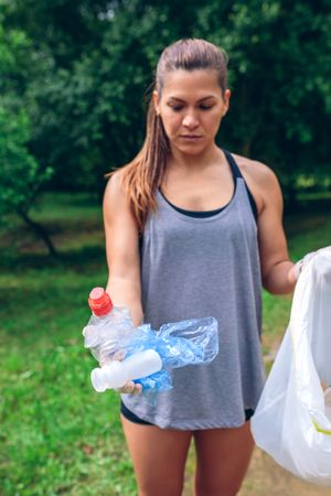 Woman showing garbage she has collected