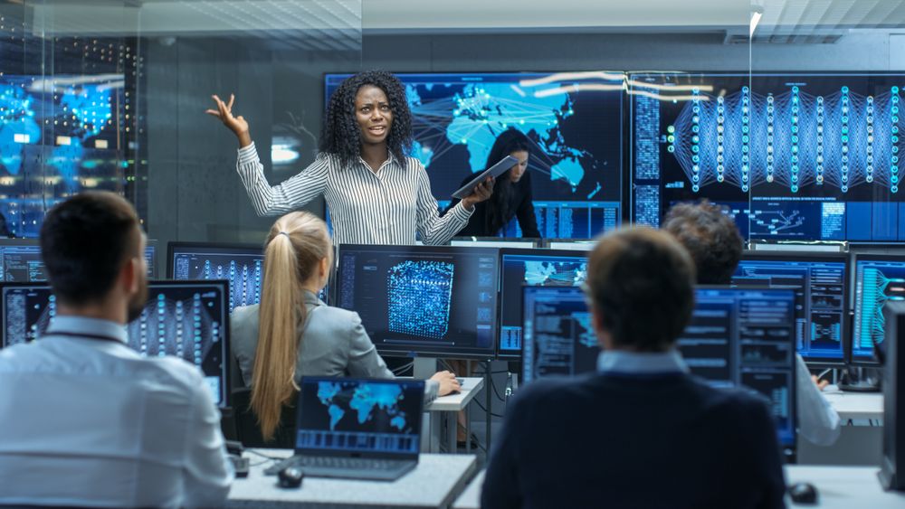 Chief Project Engineer Holds Briefing for a Team of Scientists that are Building Machine Learning System.