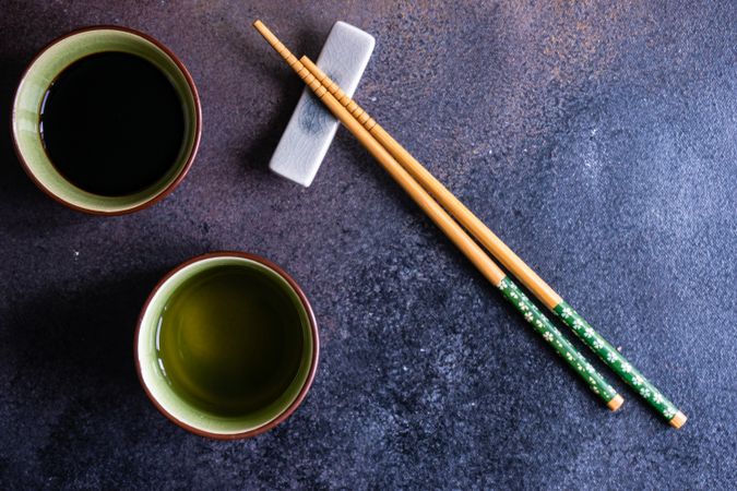 Two cups of tea with chopsticks
