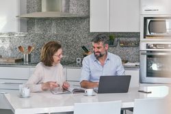 Mother and adult son spending time together in kitchen a