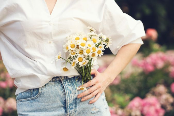 Woman with a bouquet of chrysanthemums. Background flowers