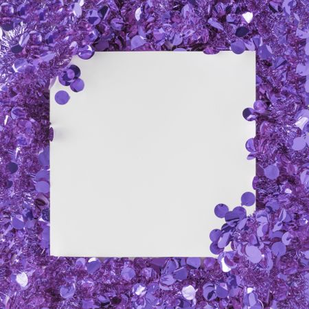 Purple confetti bordering light paper card