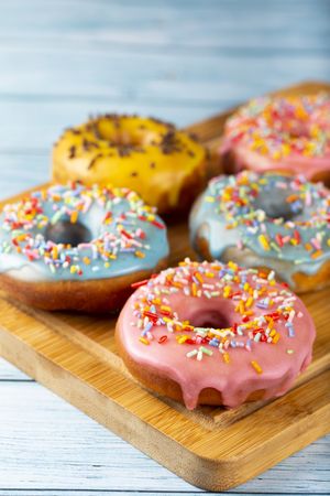 Delicious assorted colorful donuts on the table.