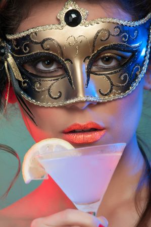 Woman in mask holding glass of drink