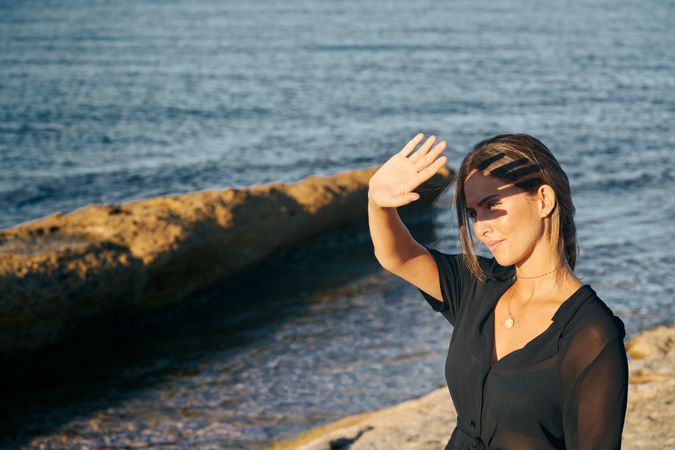 Calm woman enjoying sun on beach