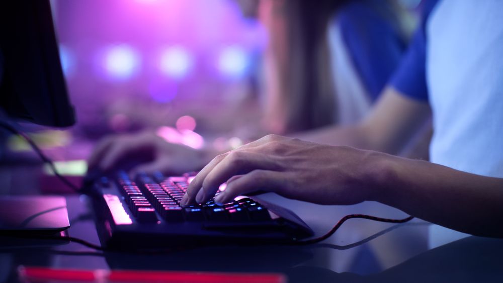 Close-up On Gamer's Hands on a keyboard, Actively Pushing Buttons, Playing MMO Games Online.