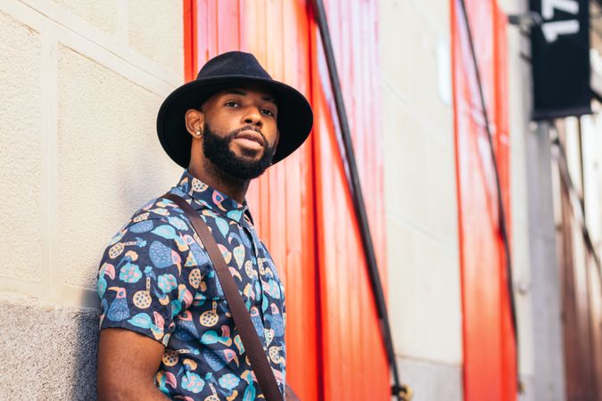 Portrait of a stylish Black man in hat and alternative outfit