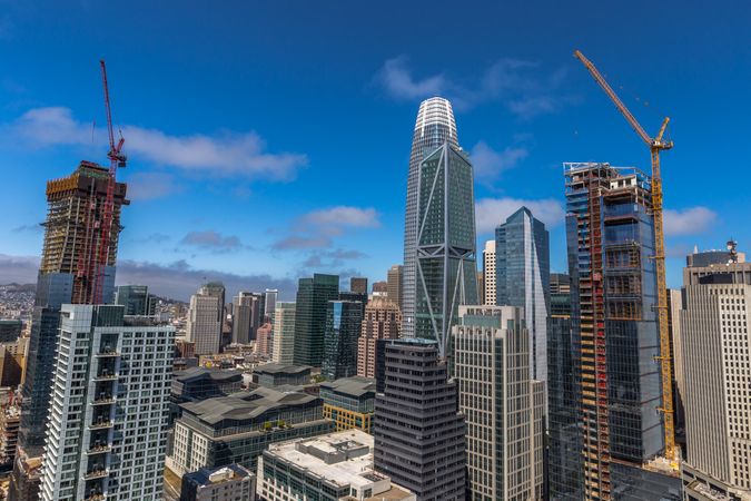 High rise building and pulleys under blue sky