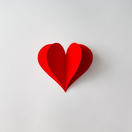 Paper heart shape decoration on background