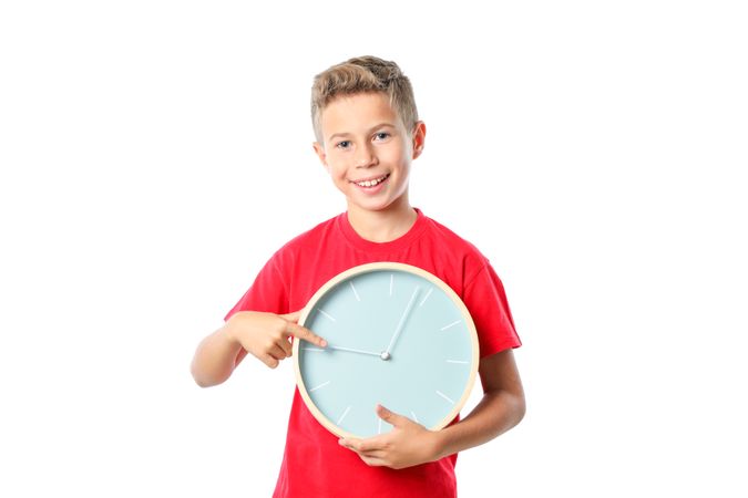 Boy in red t-shirt with clock isolated on blank background