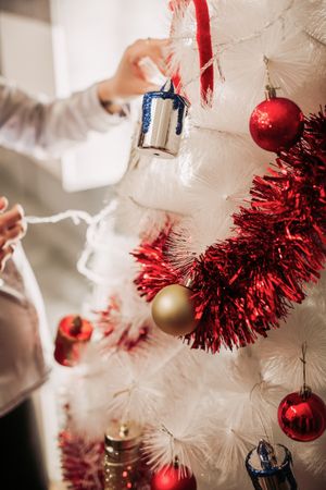 Pregnant woman arranging Christmas tree
