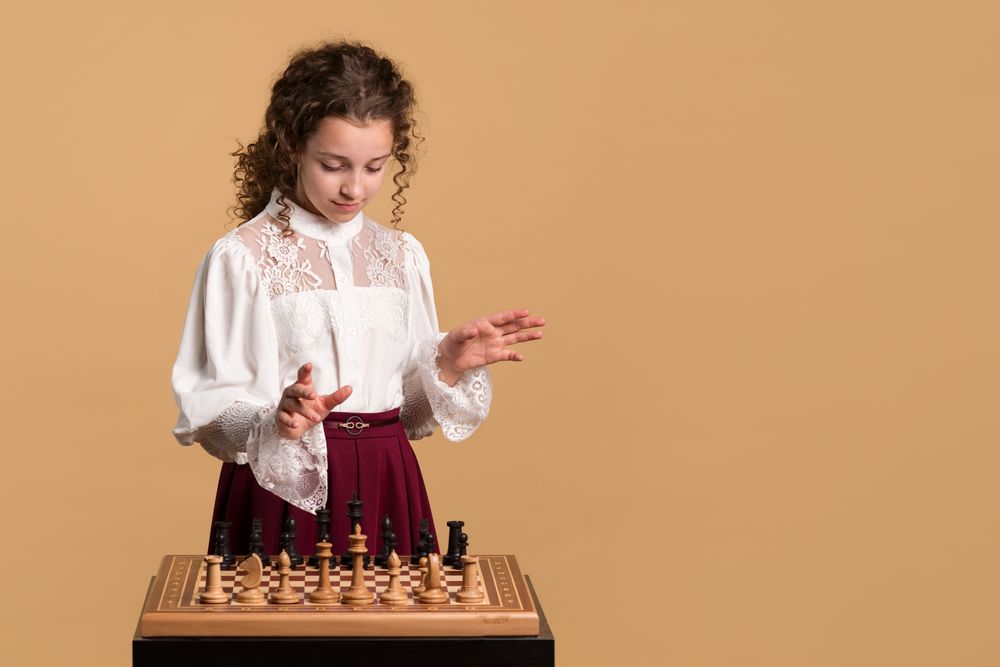 Young girl looking at chessboard in concentration