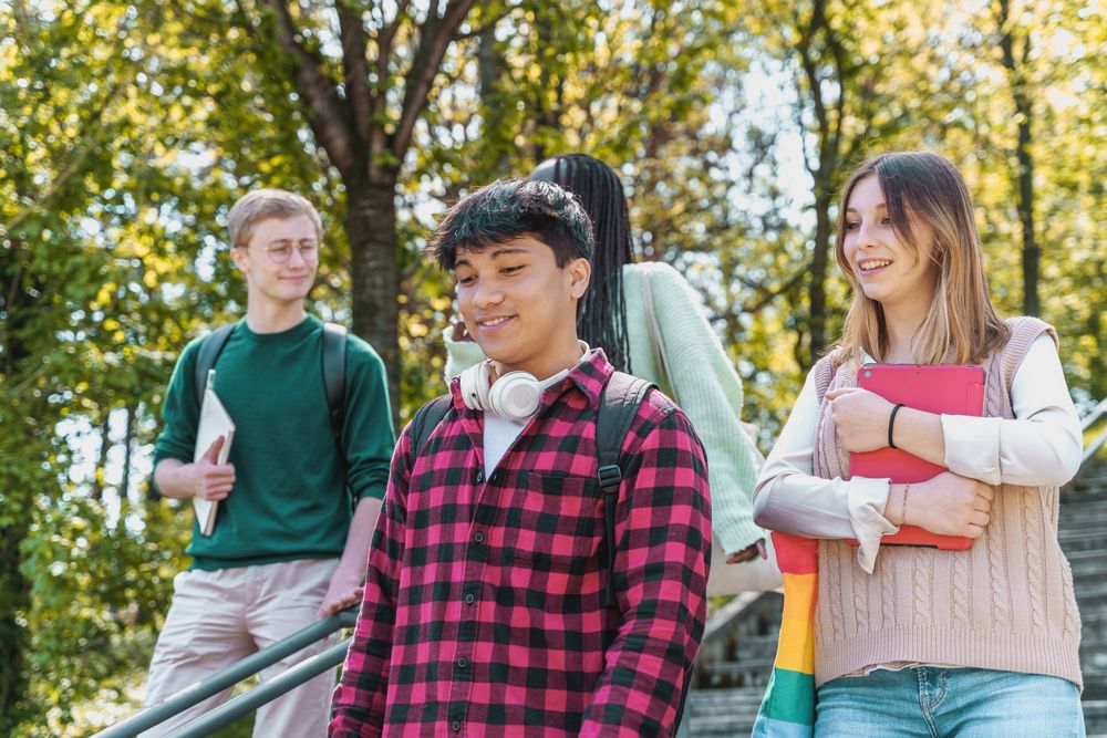 Happy students walking down stairs on campus