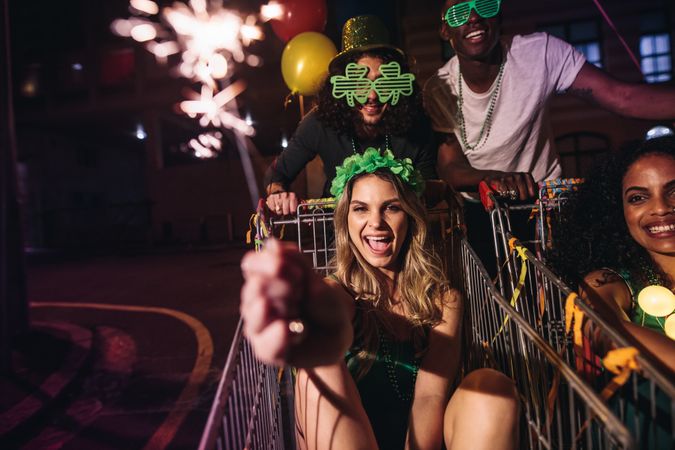 Friends celebrate St.Patrick's day with sparklers at night