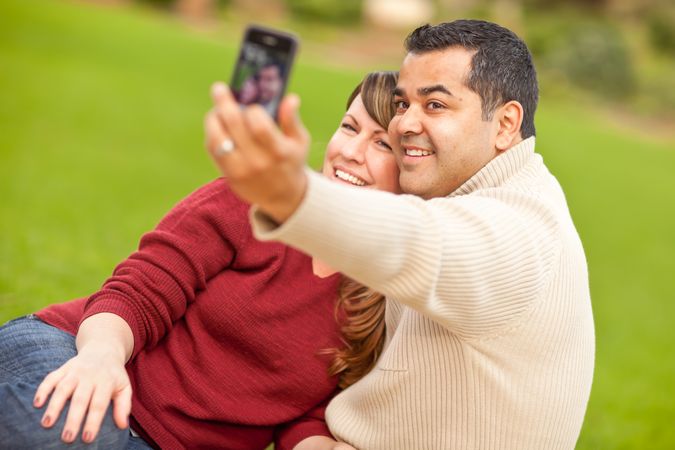Couple Taking Self Portraits in the Park