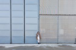 Trendy female near modern buildings