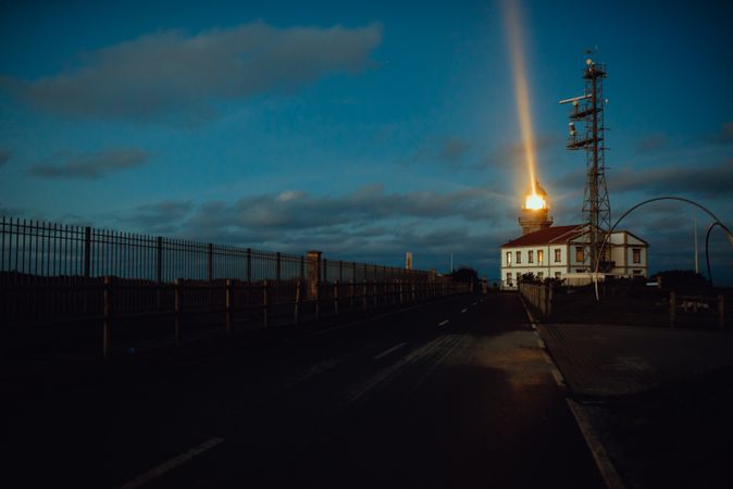 Road and lighthouse in evening