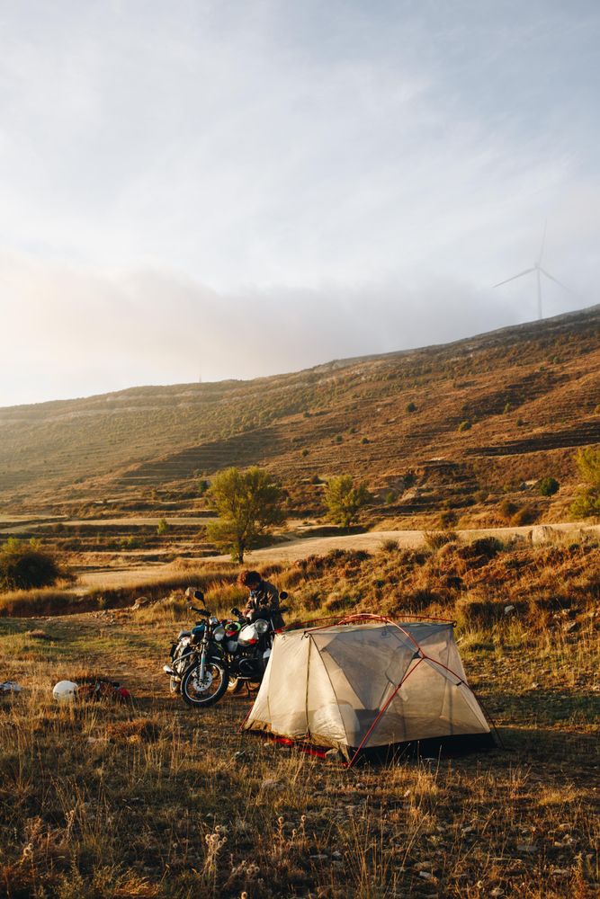 Man with motorcycle and tent, portrait