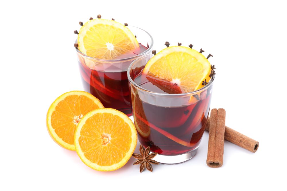 Glasses of tasty mulled wine with orange isolated on plain background