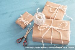 Three presents wrapped in brown paper and tied with twine bDK1p4
