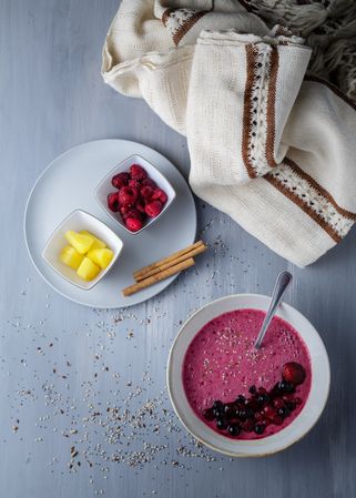 Smoothie bowl with fresh berries and sesame served on table