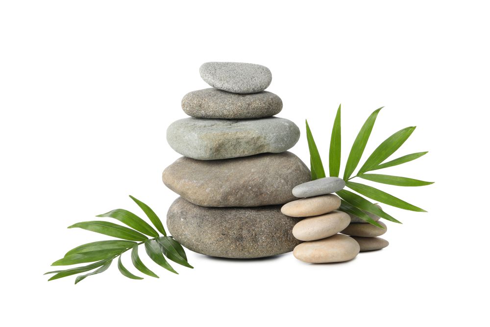 Stones and tropical leaves, isolated on plain background