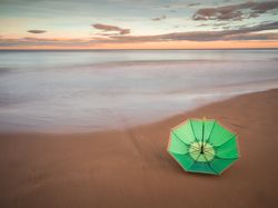 Umbrella on beach near sea