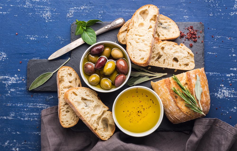 Top view of Mediterranean olives, oil and bread