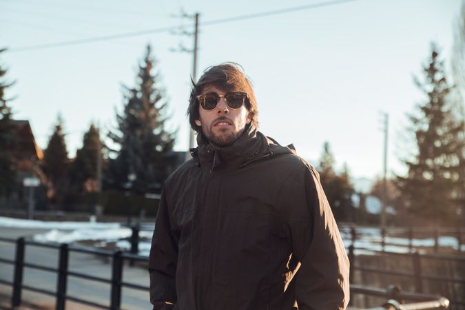 Men wearing sunglasses near hill in winter