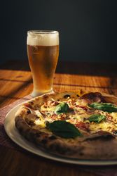 Grilled flatbread sandwich with greens on plate at restaurant