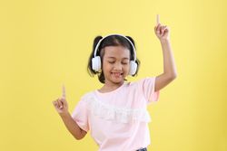 Cute Asian Kids Listening to Music using  Wireless Headset