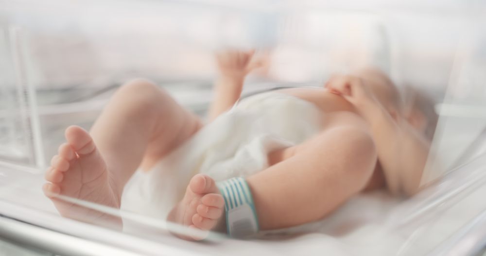 Cute Little Newborn Baby Lying in Bassinet in a Maternity Hospital.