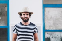 Young male in hat and striped t-shirt