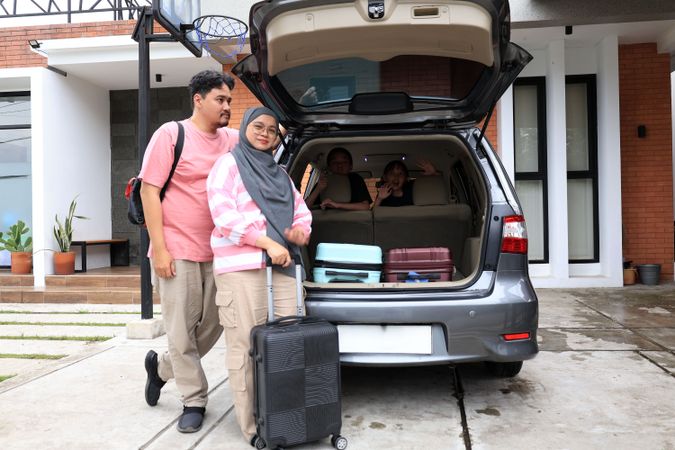 Happy Asian Muslim Family Going on Mudik Road Trip Back Home During Eid Mubarak Celebration