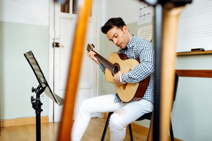 Man playing guitar in studio