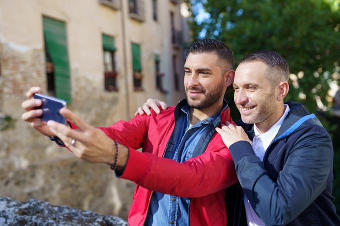 Two men taking selfie outside