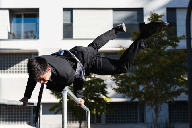 Businessman doing parkour in city district