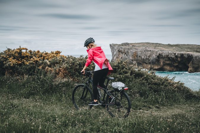 Female on bicycle enjoying landscape
