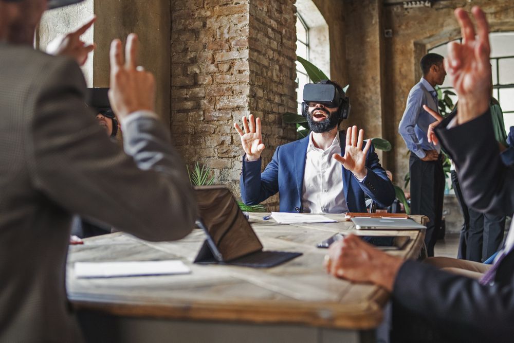 Group of business entrepreneurs working on a 3D project in metaverse wearing VR goggles