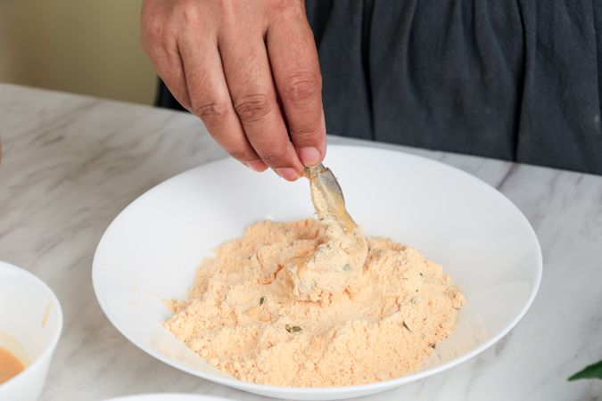 Female Hand Coating Prawn with Flour