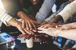 Multi-ethnic group of businesspeople joining hands in stack