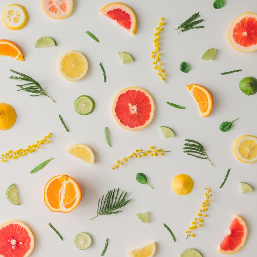 Colorful vegetable pattern made of lemon, grapefruit, lime and yellow flowers