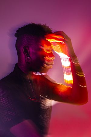 Traces of light on faces of dancer
