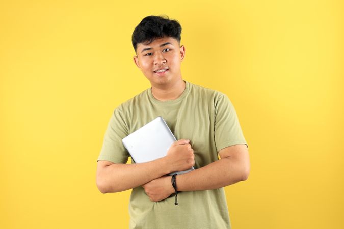 Young Asian man Holding Tablet Computer