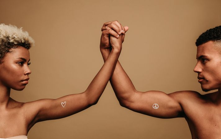 Black couple standing together holding hands in unity