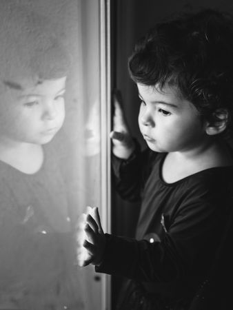 portrait of pensive boy near a window