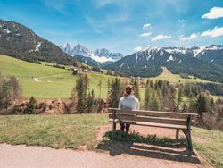 woman admiring the views of Small beautiful village between mountains with snow