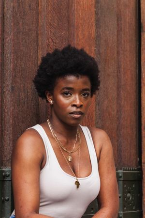 Sad Black woman with Afro hairstyle looking at camera