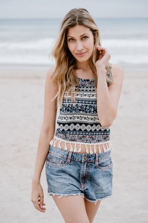 Happy female laughing on sandy beach
